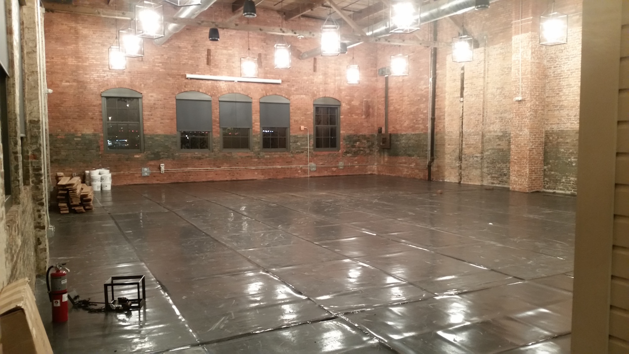 Finished hardwood floor over retrofit soundproofing membrane assembly