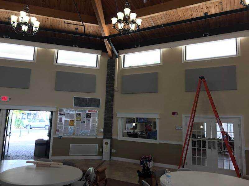 Acoustic panels installed on clubhouse walls centered on existing windows