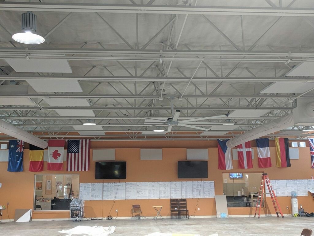 acoustic treatment in large fitness studio - ceiling clouds hung from ceiling