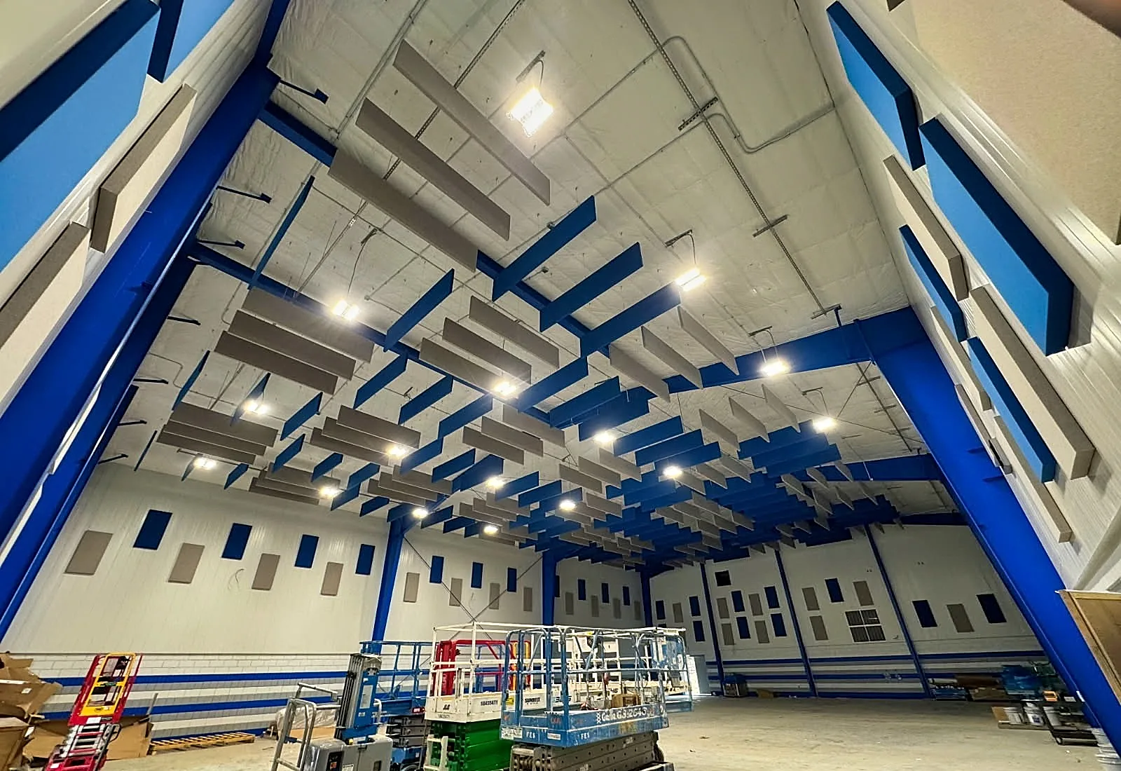 Suspended baffles control echo for improving speech.