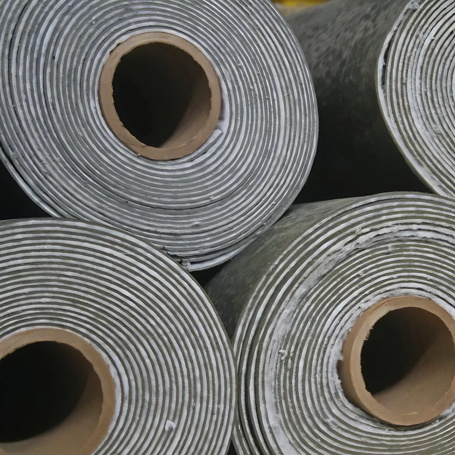 Close-up of multiple Wall Blokker Pro Rolls showing dense MLV Soundproofing for Commercial Noise Control | Produced By: Commercial Acoustics