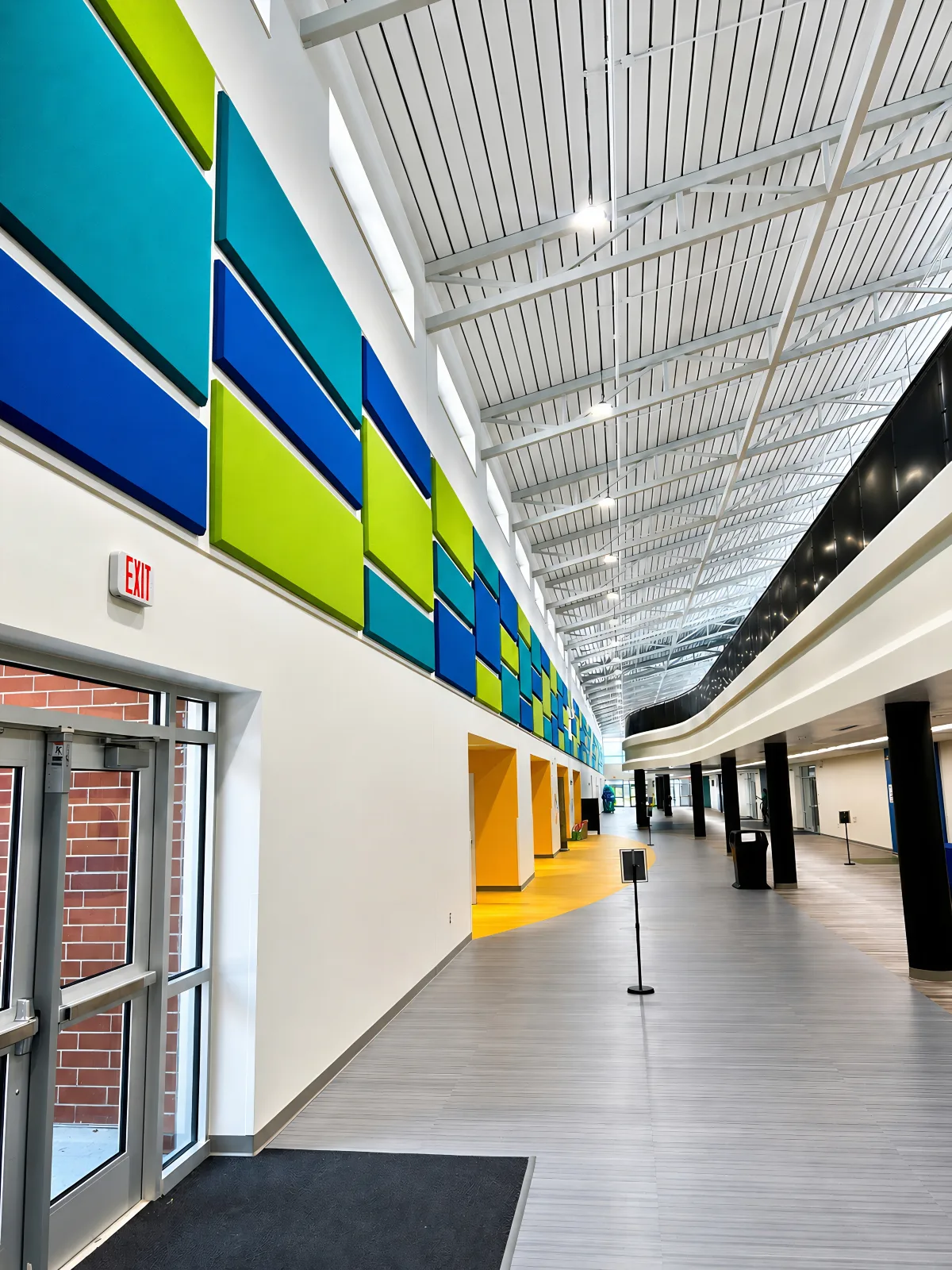 Acoustic wall panels installed high on corridor walls during new construction at North River Middle School