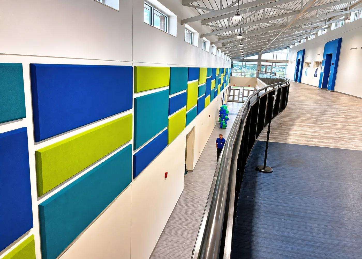 Acoustic panels reducing reverberation in a wide middle school corridor at North River Middle School