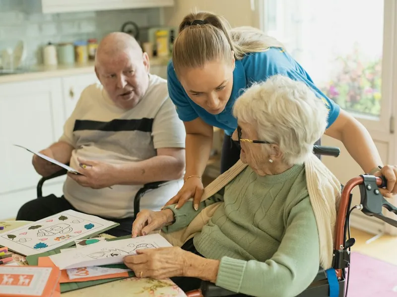 Senior Living Caregiver With Residents